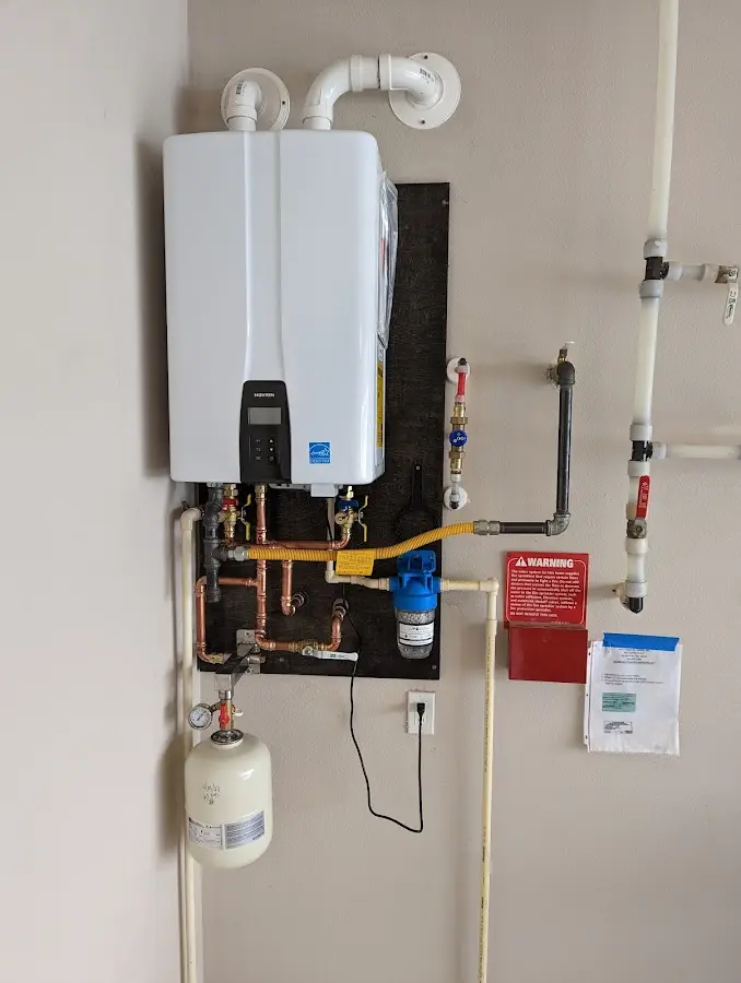 Professional plumber installing copper piping in a Jamestown home